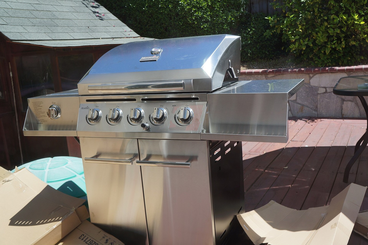 A gas barbecue on a patio, shown as a contrast to pellet-fueled cooking.